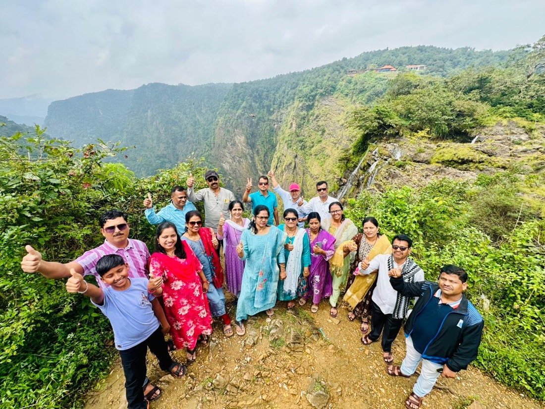 Group of happy travelers at the Jog Falls viewpoint